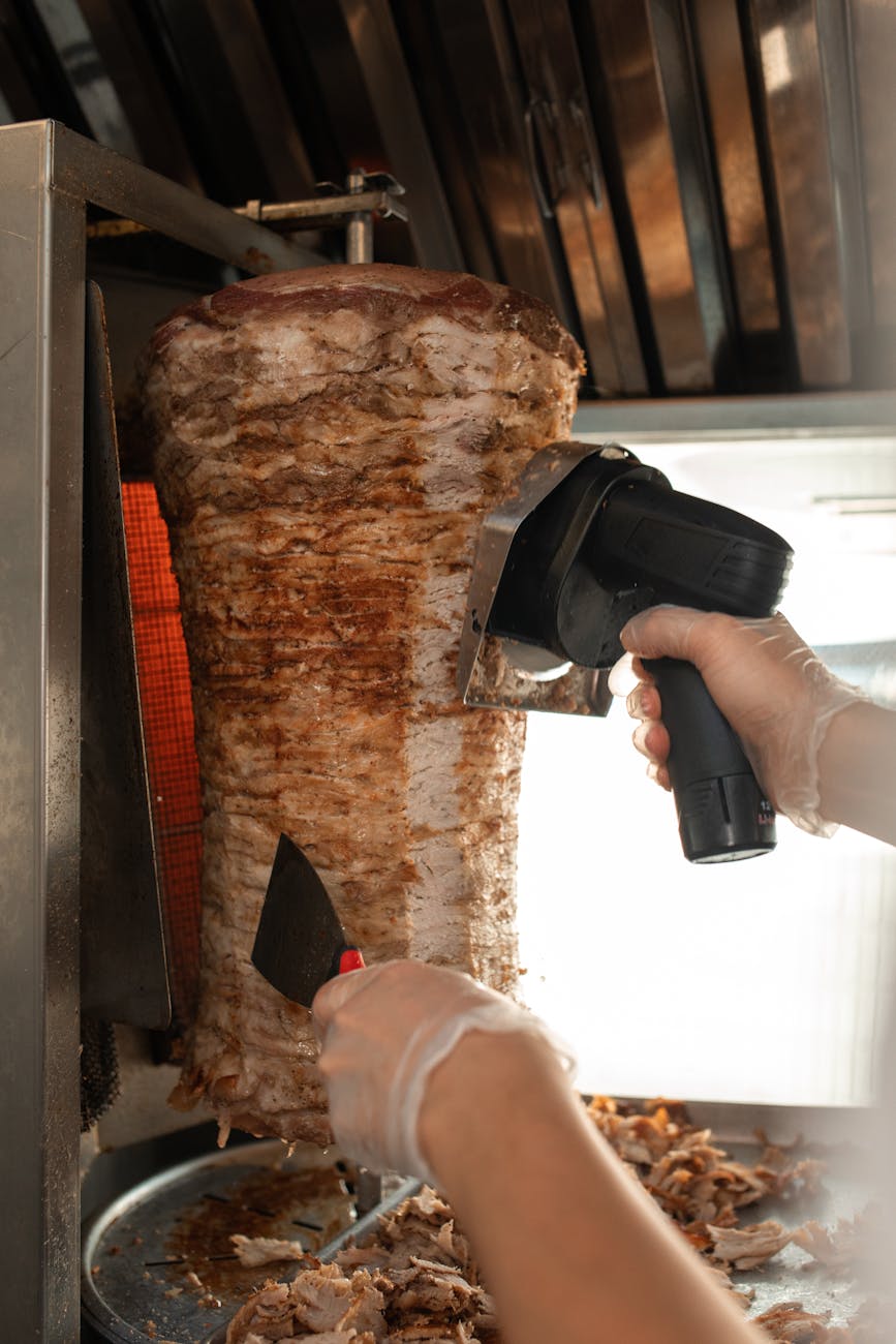 a person holding shawarma